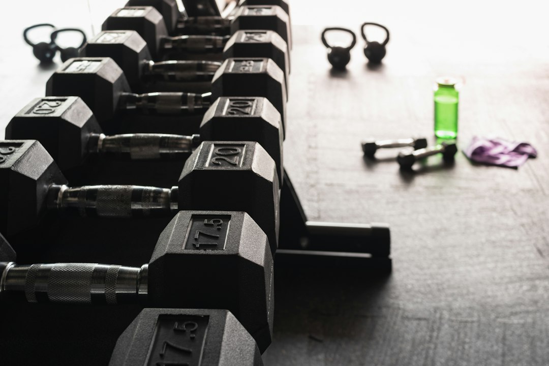 Dumbbells, kettlebells and a water bottle in a gym
